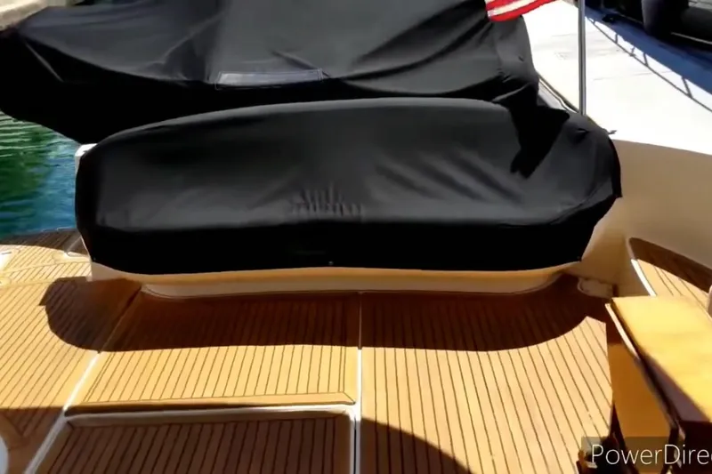Slide: The Image of 2011 Meridian 441 Sedan yacht deck with covered seating and wooden flooring. - 5