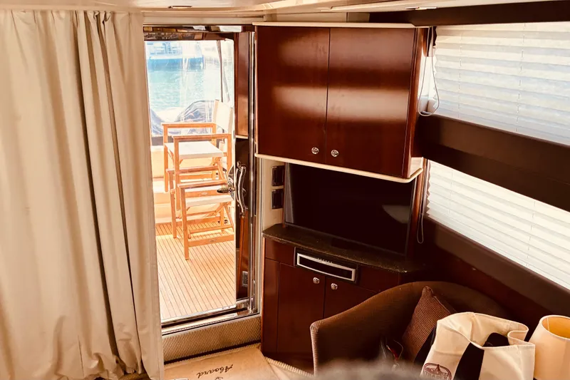 Slide: The Image of Interior of 2011 Meridian 441 Sedan yacht with elegant wood cabinetry and outdoor seating. - 9