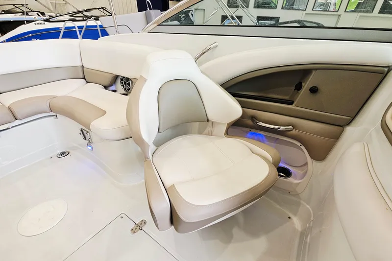 Slide: The Image of Interior of 2014 Crownline 255 SS boat with beige and white seating. - 10