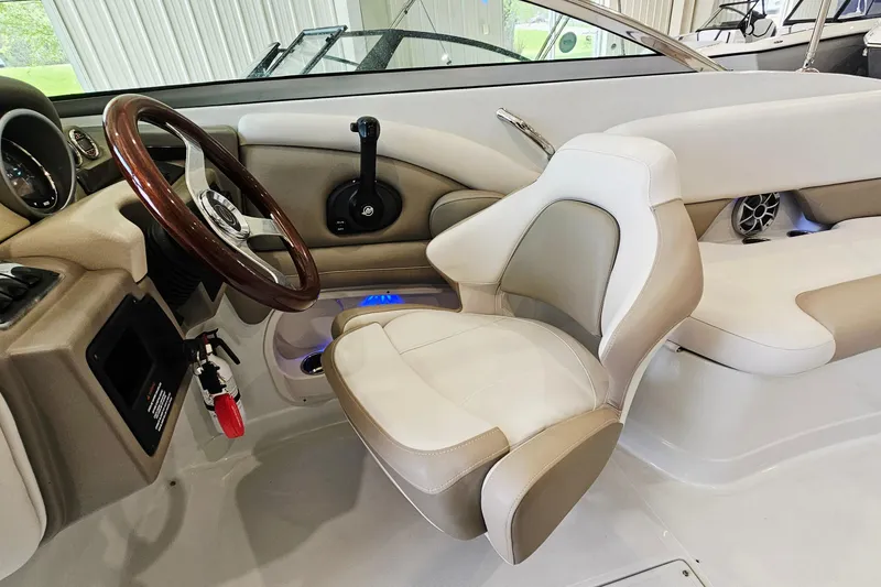 Slide: The Image of Interior of 2014 Crownline 255 SS boat featuring steering wheel and seating. - 11