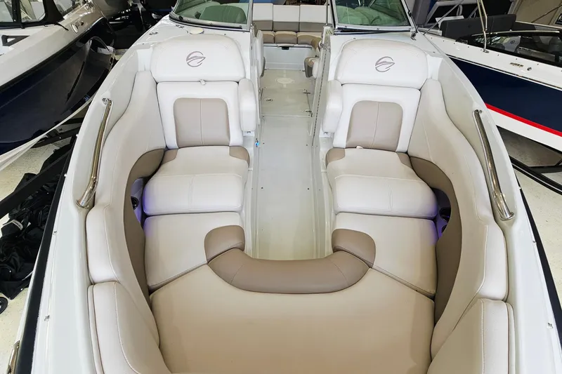Slide: The Image of 2014 Crownline 255 SS boat interior with beige seating and sleek design. - 16