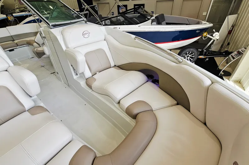 Slide: The Image of 2014 Crownline 255 SS boat interior with beige and white seating, showcasing luxury design. - 17
