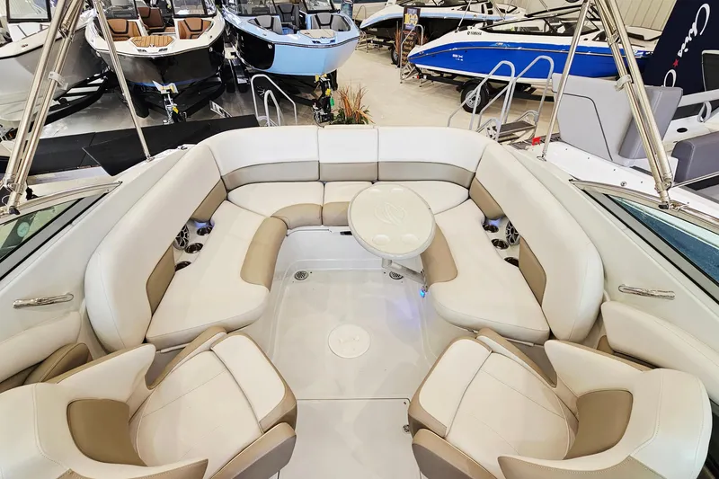 Slide: The Image of 2014 Crownline 255 SS boat interior with beige and white seating in showroom. - 19