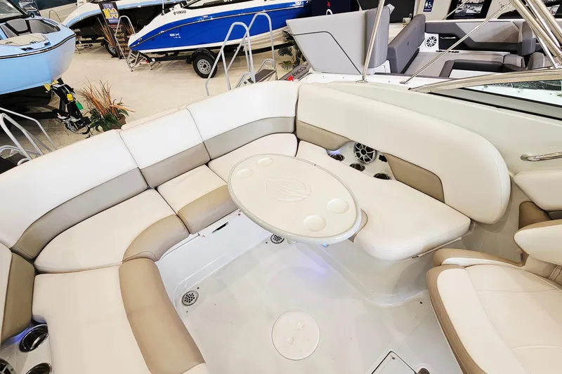 Slide: The Image of 2014 Crownline 255 SS boat interior with beige seating and round table. - 20