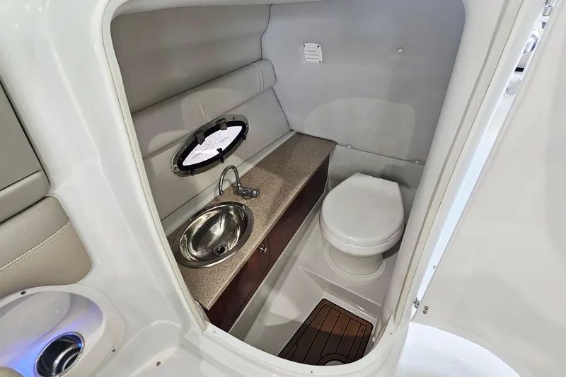 Slide: The Image of 2014 Crownline 255 SS boat interior bathroom with sink and toilet. - 22