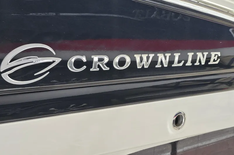 Slide: The Image of 2014 Crownline 255 SS boat logo on sleek black and white hull. - 30