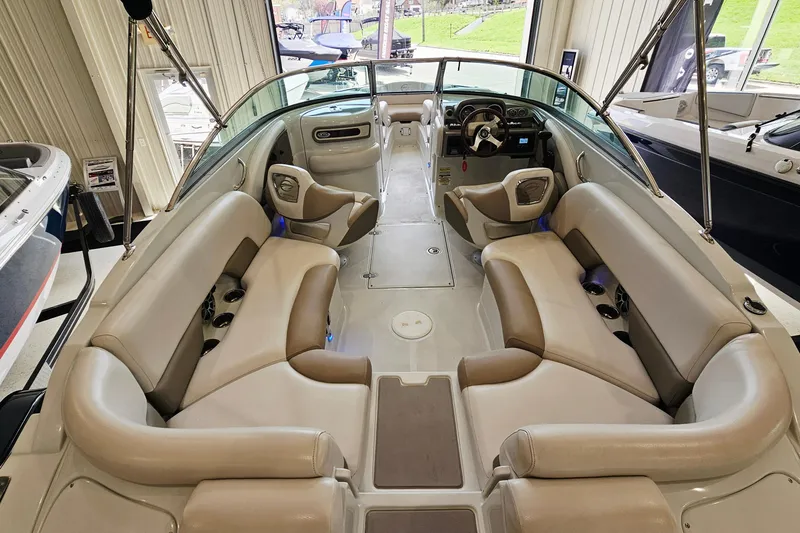 Slide: The Image of 2014 Crownline 255 SS boat interior with beige seating and modern dashboard. - 6