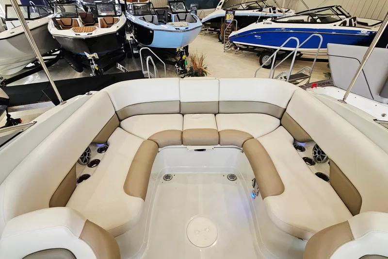 Slide: The Image of 2014 Crownline 255 SS boat interior with spacious seating in a showroom. - 8