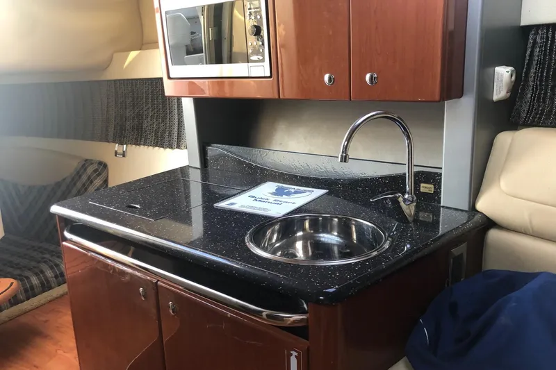 Slide: The Image of Interior of 2009 Formula 350 Sun Sport boat with kitchenette and seating area. - 11