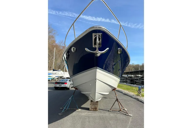 Slide: The Image of 2009 Formula 350 Sun Sport boat on stands, marina background, clear sky. - 2