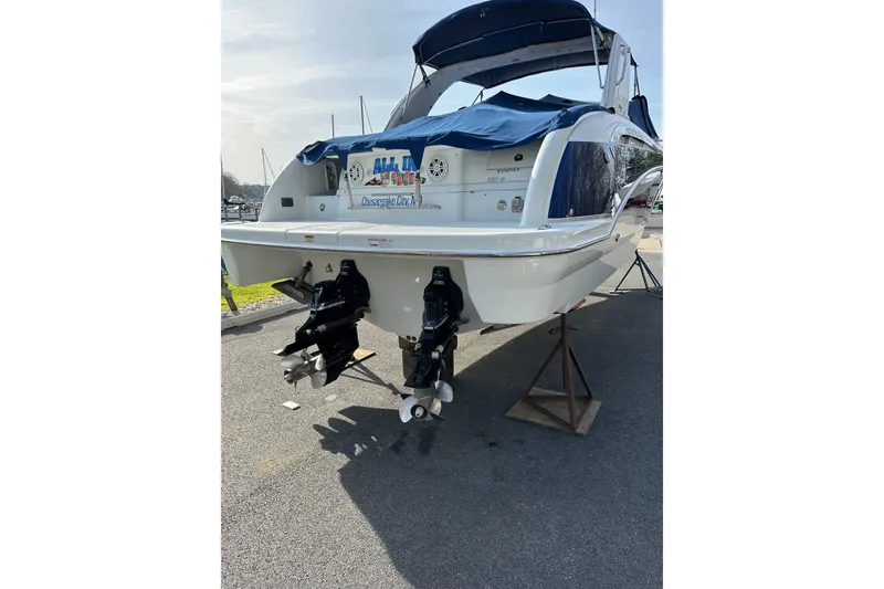 Slide: The Image of 2009 Formula 350 Sun Sport boat on stands, rear view with dual propellers. - 3