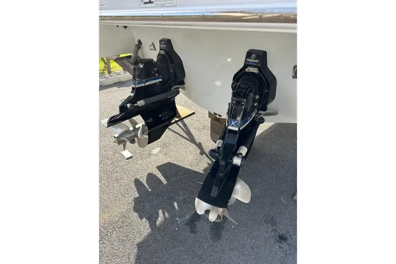 Slide: The Image of 2009 Formula 350 Sun Sport boat with dual Mercury outdrives on asphalt surface. - 4