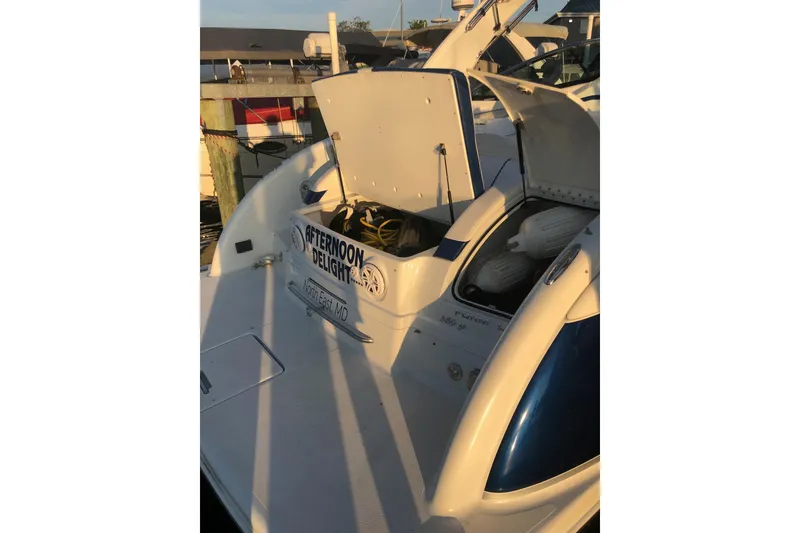 Slide: The Image of 2009 Formula 350 Sun Sport boat docked, open storage compartment, "Afternoon Delight" name visible. - 6