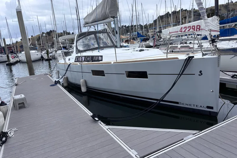 The Image of Sailboat Beneteau Oceanis 35, 2015 model, docked at marina with overcast sky. - 0