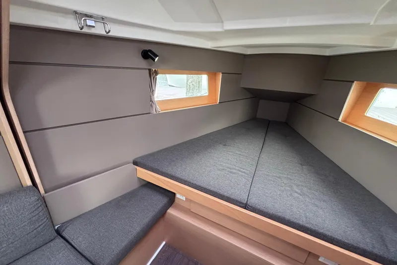 Slide: The Image of Interior cabin of 2015 Beneteau Oceanis 35 sailboat, featuring cozy sleeping area. - 13
