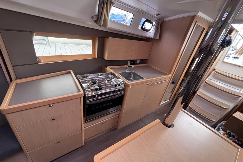 Slide: The Image of Interior of 2015 Beneteau Oceanis 35 yacht, featuring modern kitchen with stove and sink. - 15