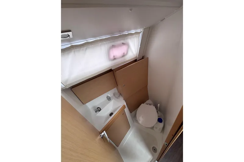 Slide: The Image of Bathroom interior of 2015 Beneteau Oceanis 35 yacht, featuring compact design and modern fixtures. - 16