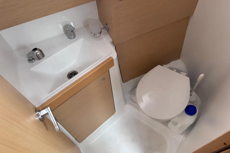 Slide: The Image of Compact bathroom in 2015 Beneteau Oceanis 35 sailboat with sink and toilet. - 18