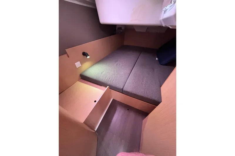 Slide: The Image of Cozy cabin interior of 2015 Beneteau Oceanis 35 sailboat with cushioned bed. - 21