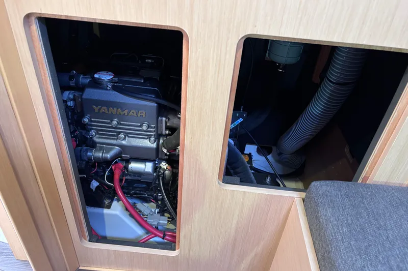 Slide: The Image of Engine compartment of a 2015 Beneteau Oceanis 35 sailboat, featuring a Yanmar engine. - 24