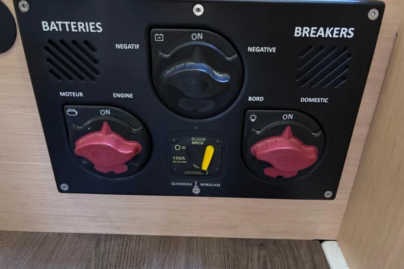 Slide: The Image of Control panel of a 2015 Beneteau Oceanis 35 sailboat, featuring battery and breaker switches. - 26