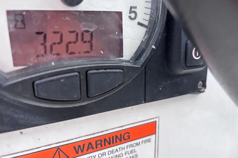 Slide: The Image of Close-up of Beneteau Oceanis 35 engine hour meter displaying 322.9 hours, with warning label. - 28