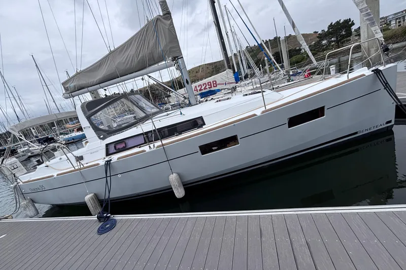 Slide: The Image of 2015 Beneteau Oceanis 35 sailboat docked at marina, showcasing sleek design and modern features. - 3