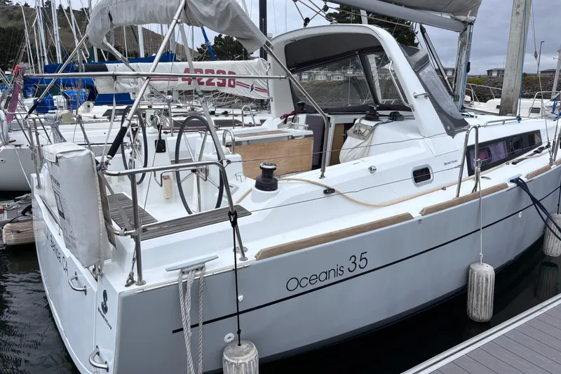 Slide: The Image of 2015 Beneteau Oceanis 35 sailboat docked at marina, showcasing sleek design and modern features. - 4