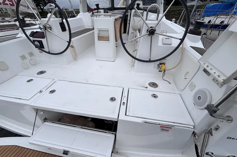 Slide: The Image of Cockpit of 2015 Beneteau Oceanis 35 sailboat with dual steering wheels and storage compartments. - 5