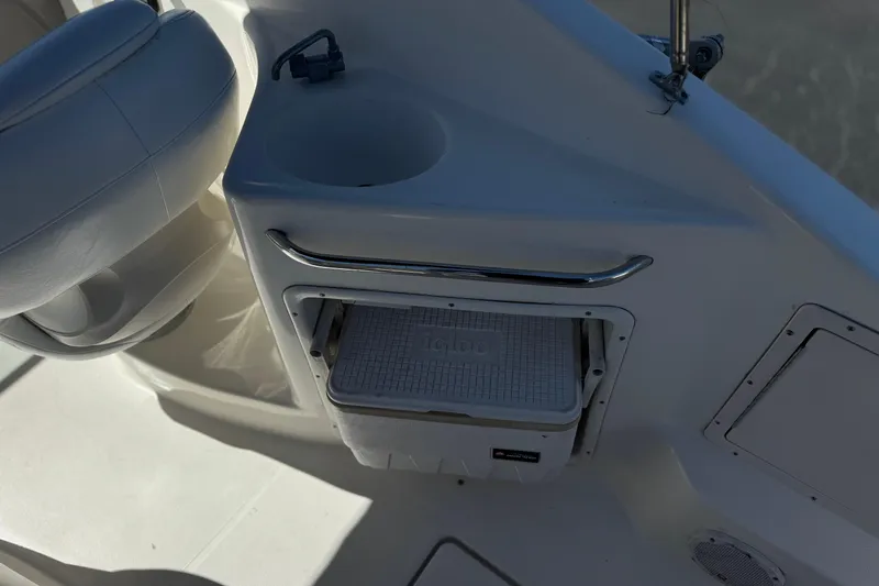 Slide: The Image of 2004 Chaparral Signature 260 boat interior with cooler storage and seating. - 16