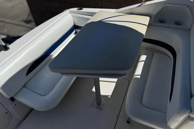 Slide: The Image of 2004 Chaparral Signature 260 boat interior with seating and table setup. - 17