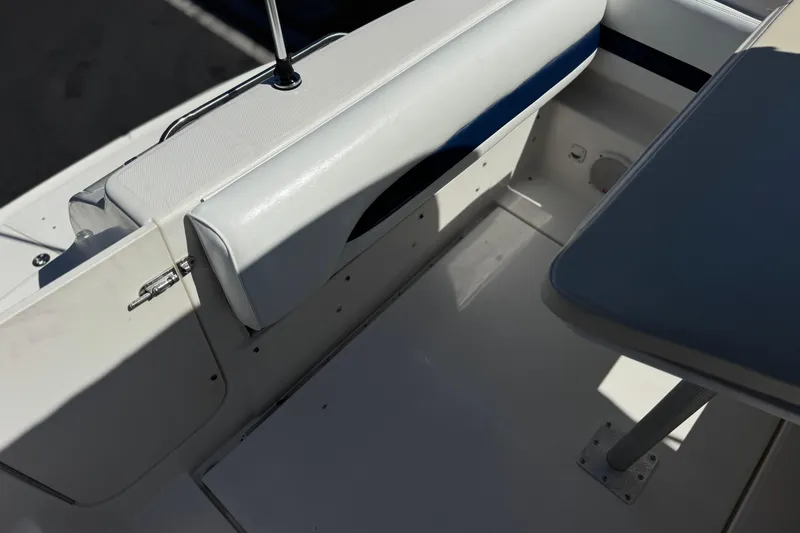 Slide: The Image of 2004 Chaparral Signature 260 boat interior with white seating and table. - 18