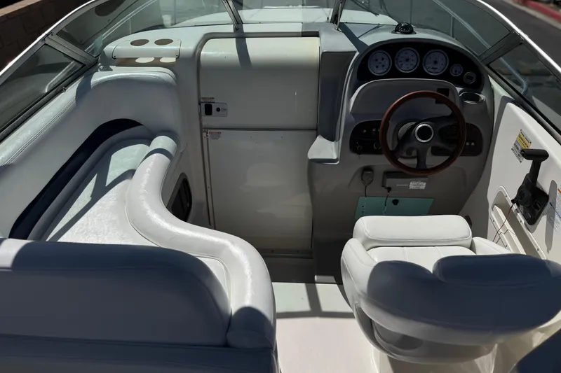 Slide: The Image of 2004 Chaparral Signature 260 boat cockpit with steering wheel and seating. - 22