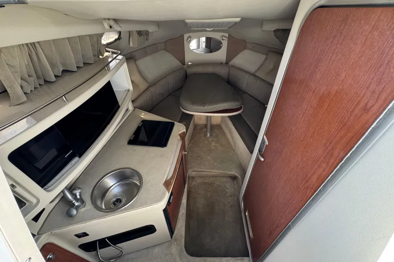 Slide: The Image of 2004 Chaparral Signature 260 cabin interior with kitchenette and seating area. - 28