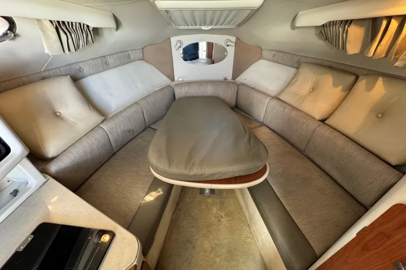 Slide: The Image of Interior of a 2004 Chaparral Signature 260 boat with cozy seating and table. - 29
