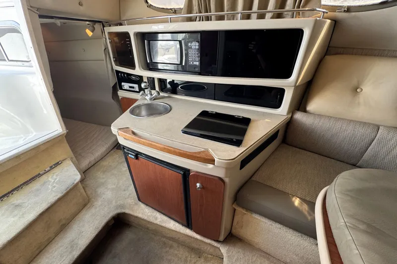 Slide: The Image of 2004 Chaparral Signature 260 cabin interior with kitchenette, sink, and seating area. - 30