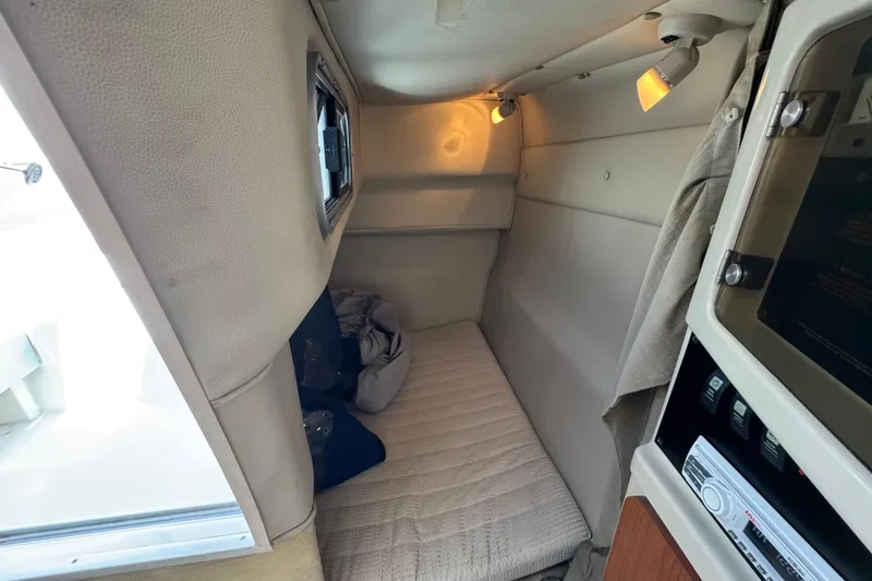 Slide: The Image of 2004 Chaparral Signature 260 cabin interior with cozy sleeping area and soft lighting. - 33