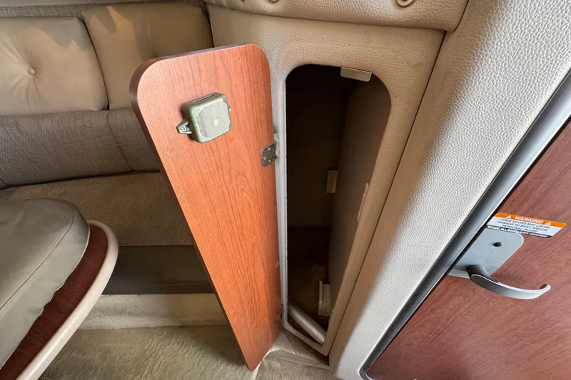 Slide: The Image of 2004 Chaparral Signature 260 interior storage compartment with open wooden door. - 34
