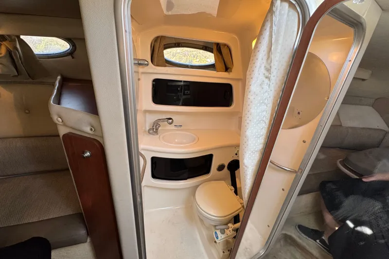 Slide: The Image of 2004 Chaparral Signature 260 boat interior with compact bathroom and seating area. - 36