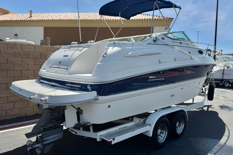 Slide: The Image of 2004 Chaparral Signature 260 boat on trailer, featuring sleek design and blue accents. - 5