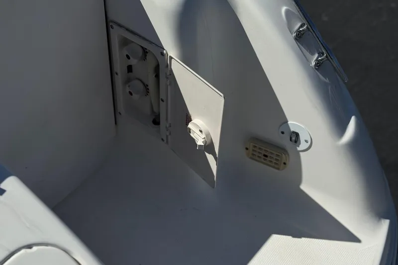 Slide: The Image of 2004 Chaparral Signature 260 boat interior detail with access panel and fittings. - 8