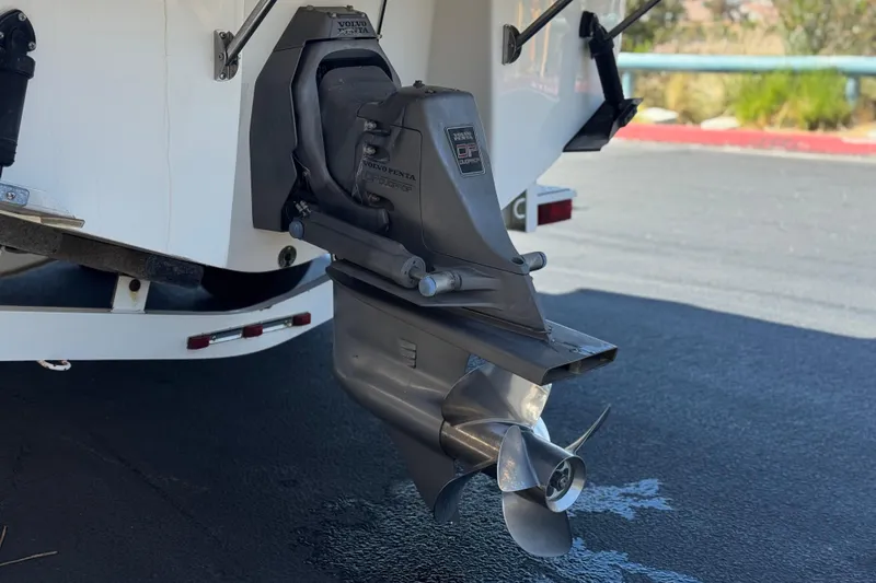 Slide: The Image of 2004 Chaparral Signature 260 boat with Volvo Penta outdrive, parked on asphalt. - 9