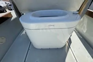 Slide: The Image of 1990 Davis Radon Craft 22 boat interior with a white storage compartment. - 13