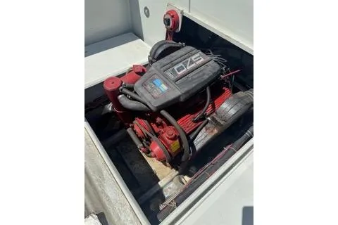 Slide: The Image of Engine of a 1990 Davis Radon Craft 22 boat, featuring red components. - 14