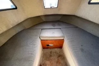 Slide: The Image of Interior cabin of 1990 Davis Radon Craft 22 boat with cushioned seating. - 16