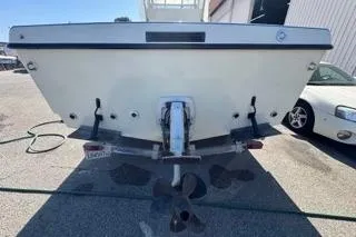 Slide: The Image of 1990 Davis Radon Craft 22 boat, rear view, parked on a trailer in a sunny lot. - 5