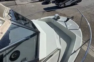 Slide: The Image of 1990 Davis Radon Craft 22 boat deck with railing and windshield in a parking area. - 6
