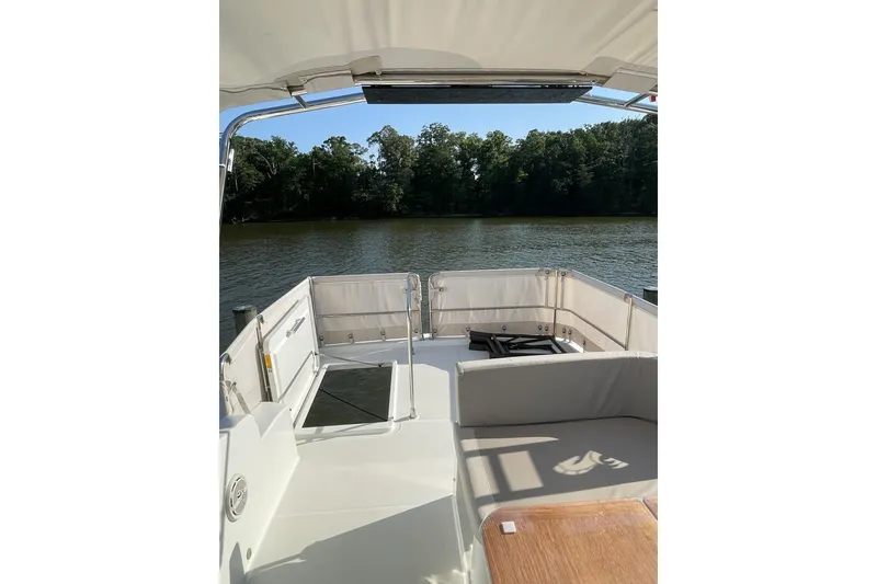 Slide: The Image of Beneteau Swift Trawler 35, 2020 model, featuring a spacious deck overlooking serene waters. - 11