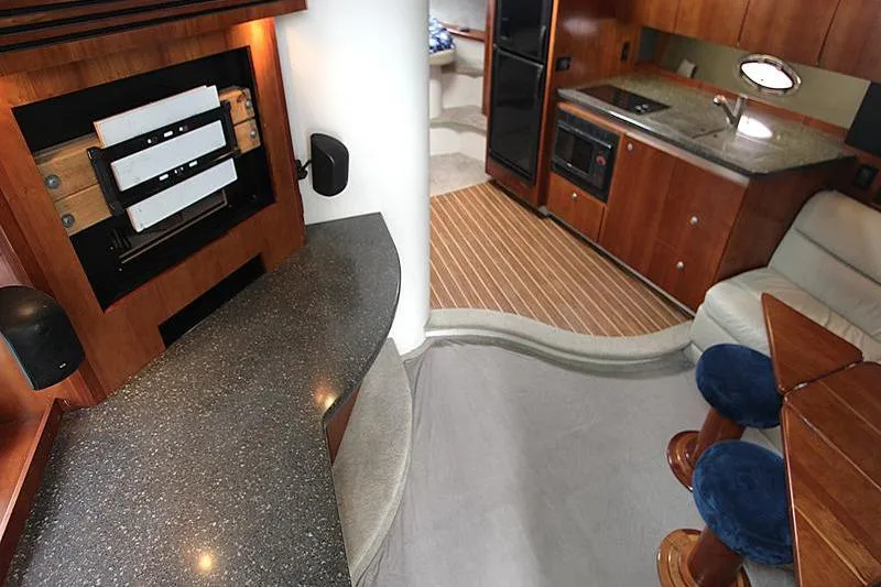 Slide: The Image of Interior of a 2007 Cruisers 420 yacht with modern kitchen and seating area. - 10