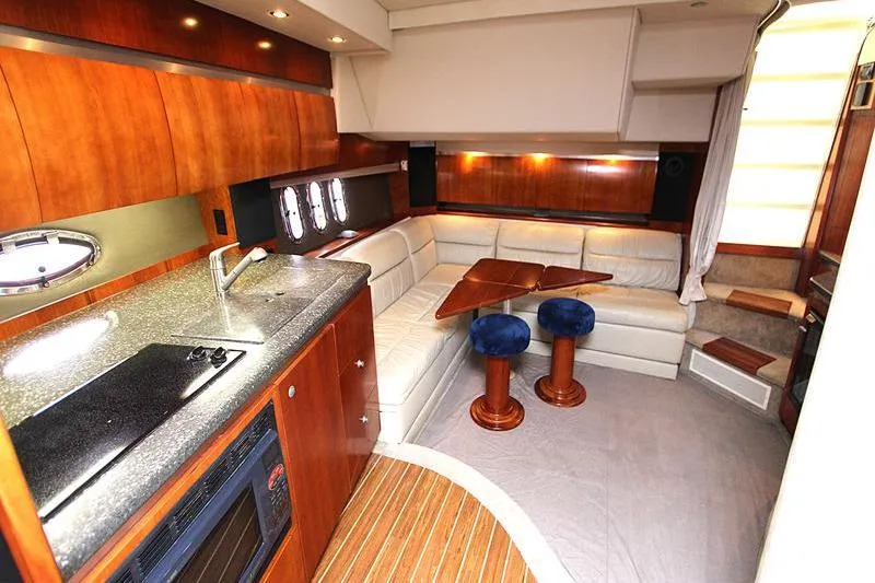 Slide: The Image of Luxurious interior of a 2007 Cruisers 420 yacht with modern kitchen and seating area. - 11